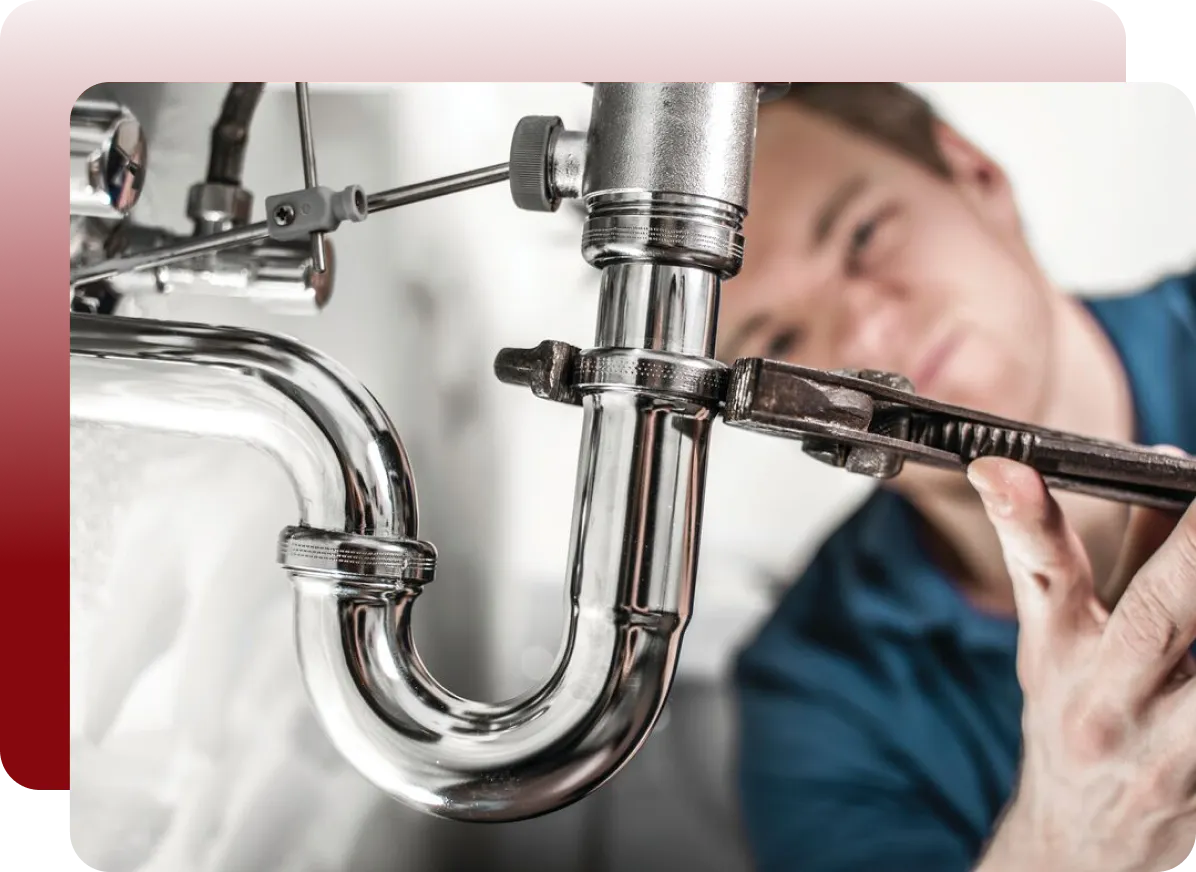plumber working under sink