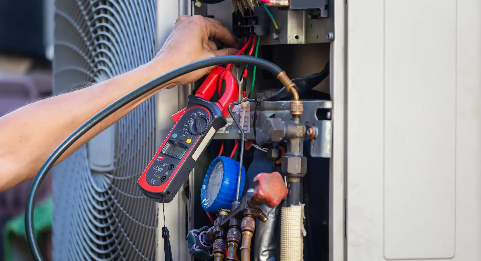 HVAC Tech working on inside of heat pump