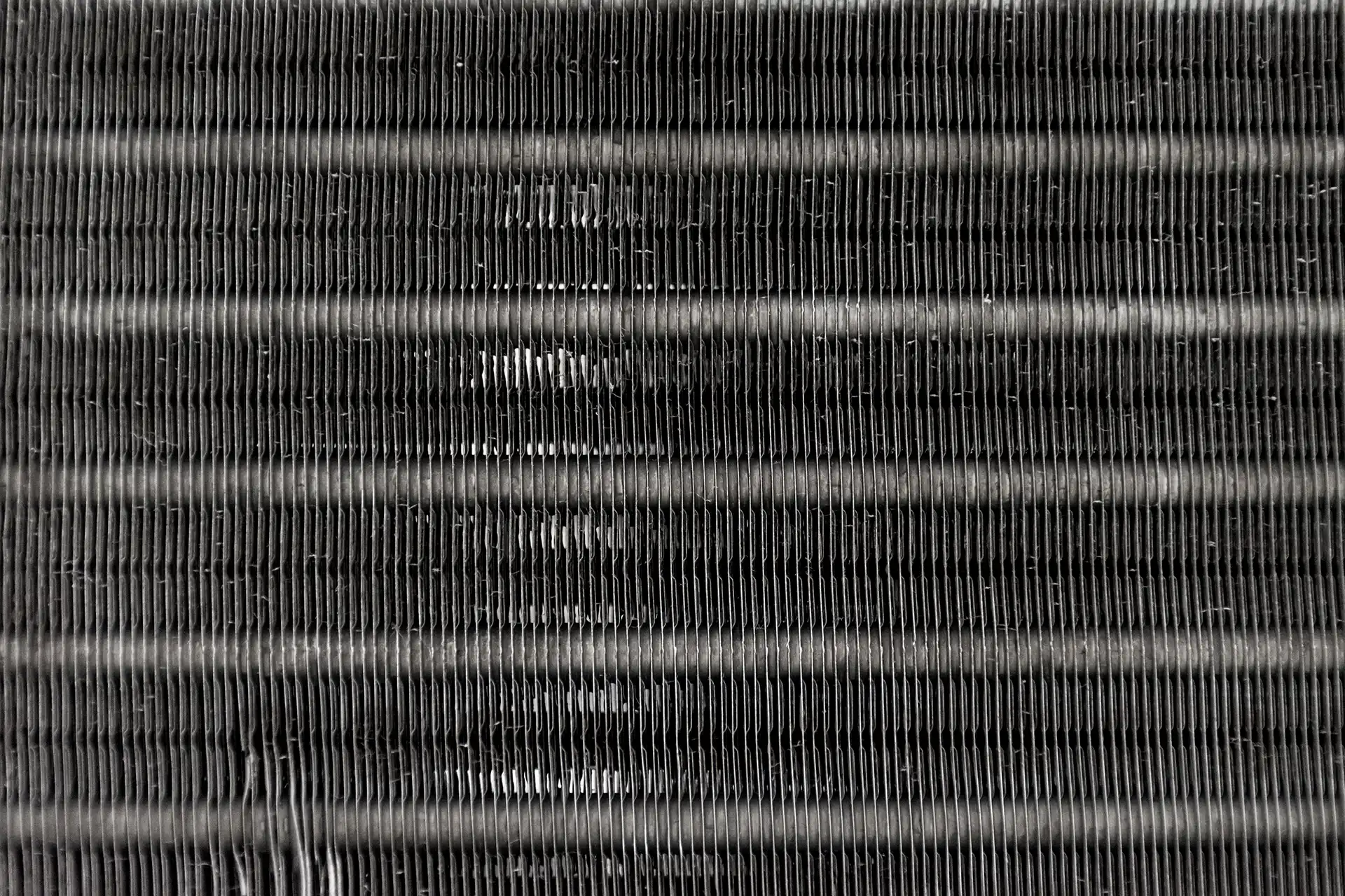 Close-up of an air conditioner evaporator coil with cooling fins