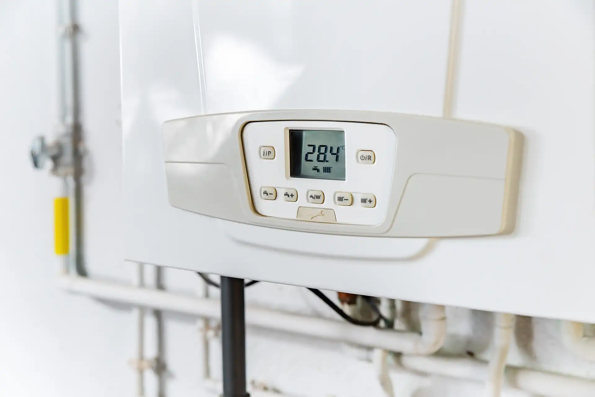 front of tankless water heater with screen reading in celcius